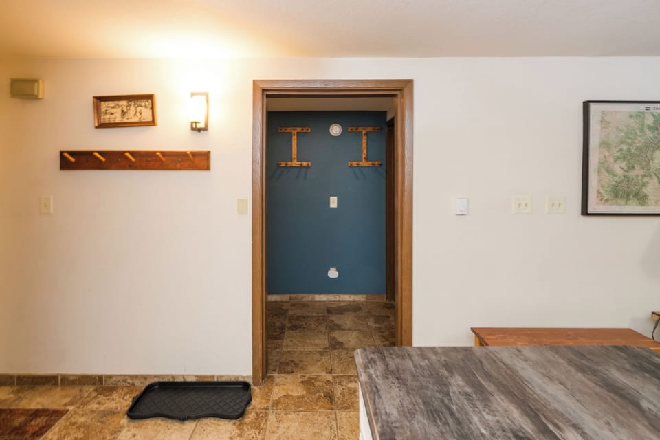 Step into your welcoming entryway where wooden coat hooks await your arrival and thoughtful touches make you feel right at home.