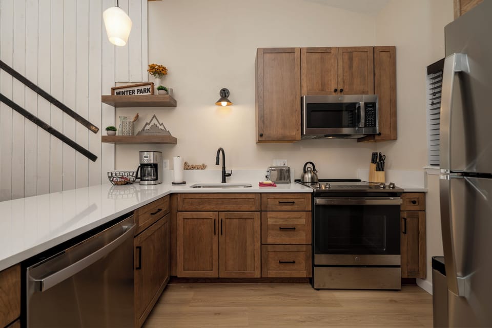 Your fully equipped kitchen features warm wood cabinets, modern appliances, and thoughtful touches to make cooking feel like home.