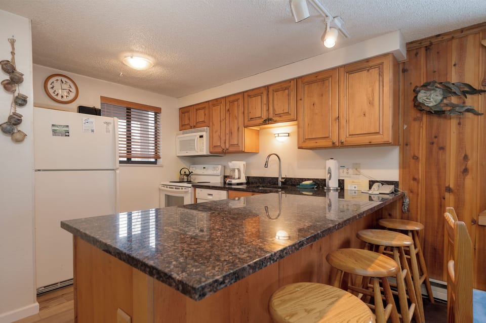 Gather around your spacious granite island kitchen with bar seating, perfect for morning coffee or evening meals together.