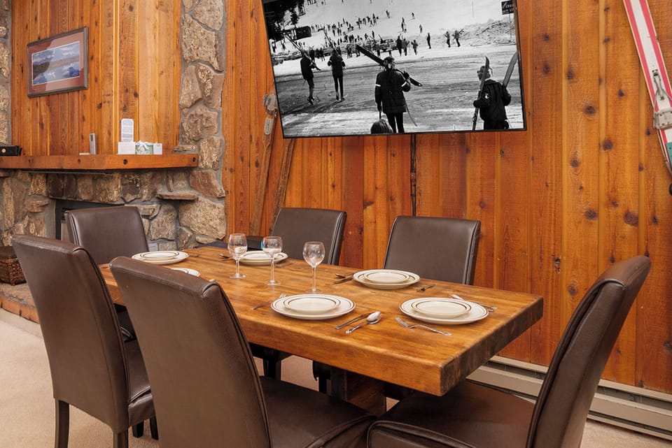 Gather around this beautiful wooden table for memorable meals by your cozy stone fireplace.