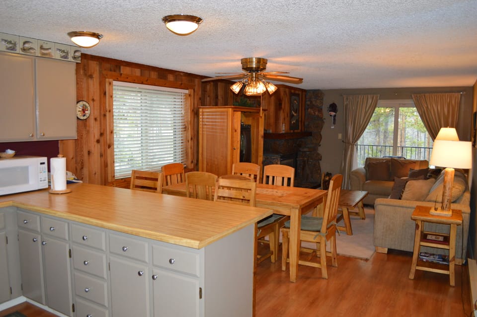Gather around your spacious kitchen island for morning coffee or evening conversations while enjoying the warm wood accents and cozy fireplace nearby.