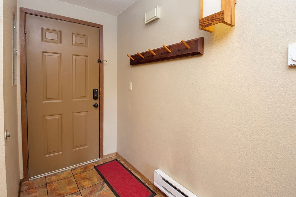 Step into your welcoming entryway with convenient wall hooks for your coats and belongings, making you feel right at home.