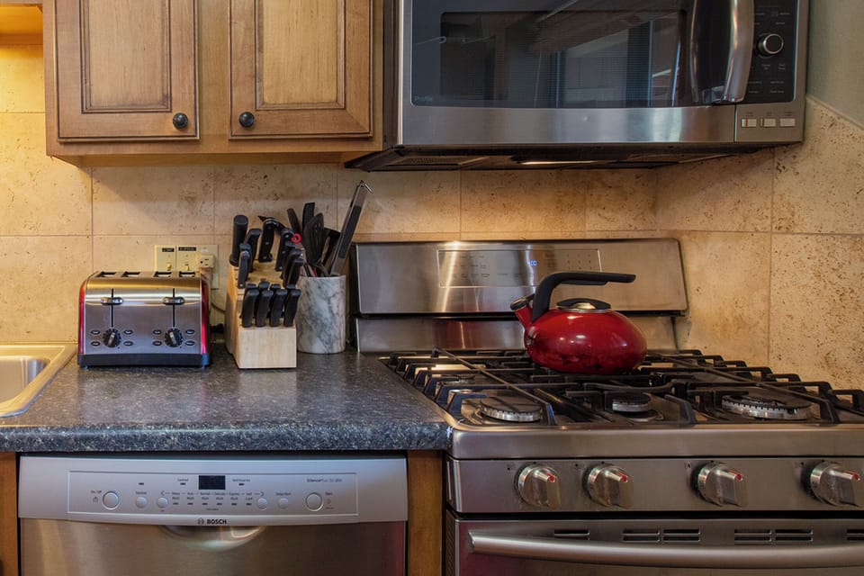 Cook your favorite meals in this fully-equipped kitchen with stainless appliances, granite counters, and professional knife set.