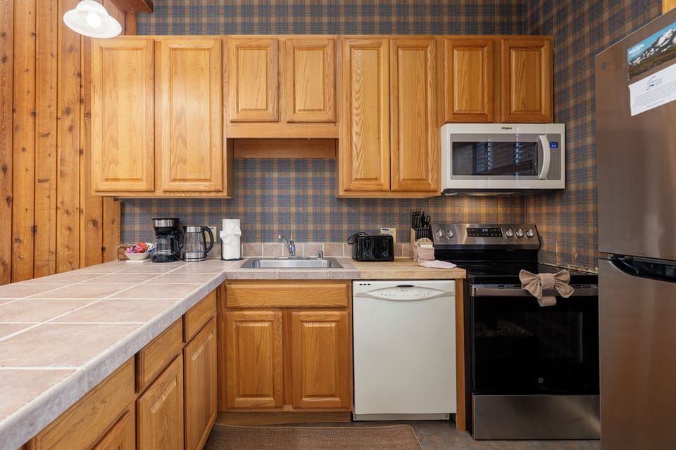 Your fully equipped kitchen features warm oak cabinets, modern appliances, and everything you need to prepare delicious meals during your stay.