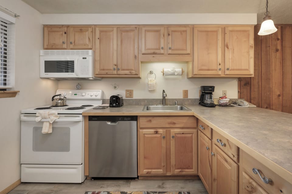 Your fully equipped kitchen features warm wood cabinets, modern appliances, and everything you need to prepare home-cooked meals during your stay.