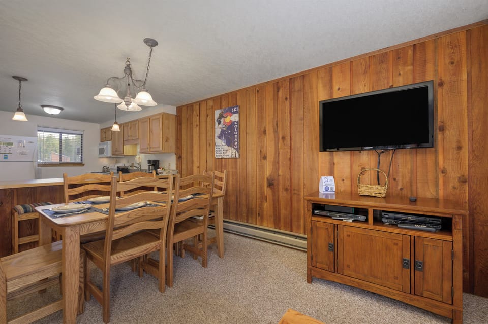 Unwind in this cozy wood-paneled living space where your entertainment center awaits after mountain adventures.