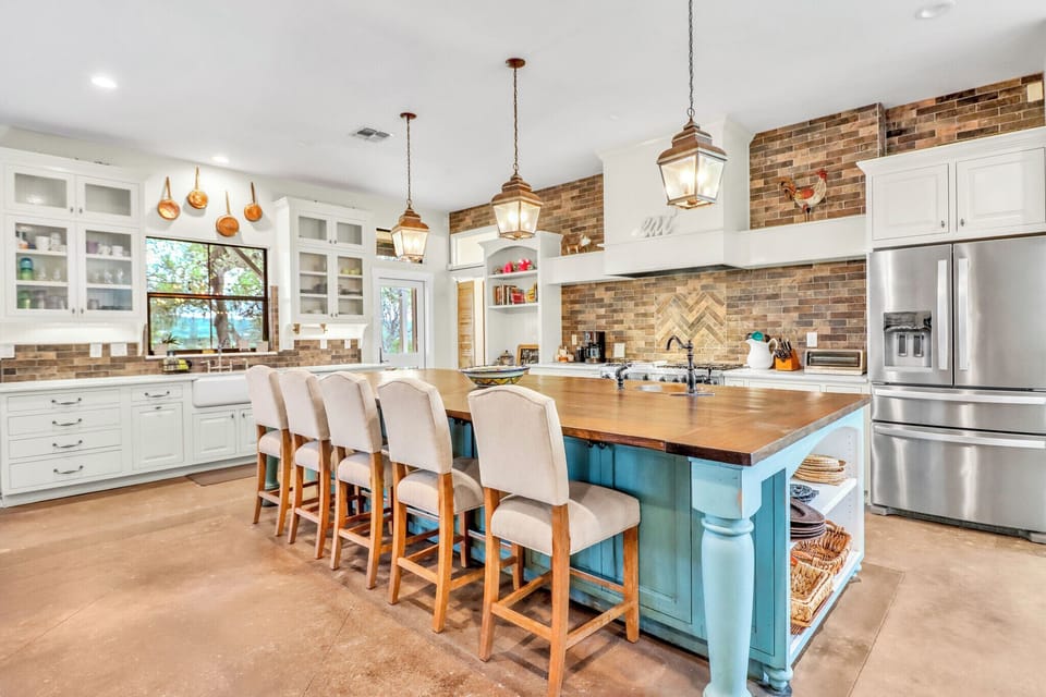 Prepare a meal at the spacious island while sunlight streams through expansive windows
