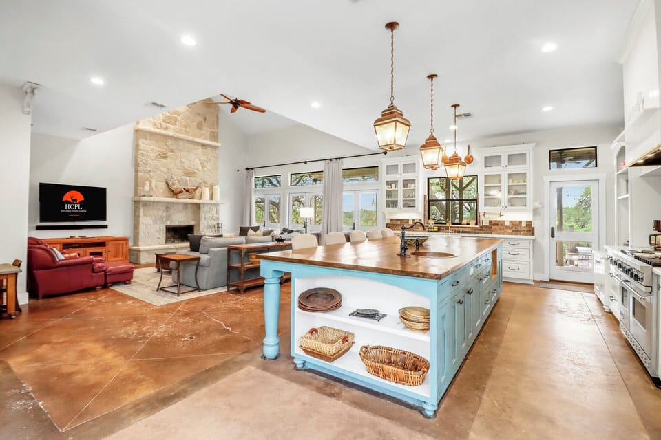 This stunning open-concept space seamlessly blends living, dining, and kitchen