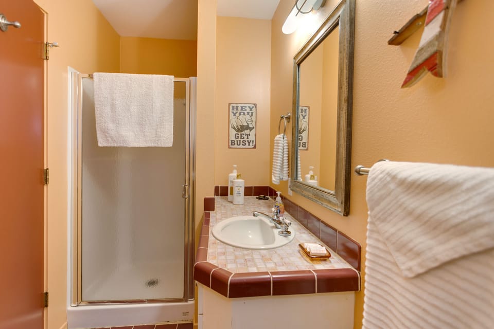 Main floor guest bath with tiled custom tile counter and shower. 