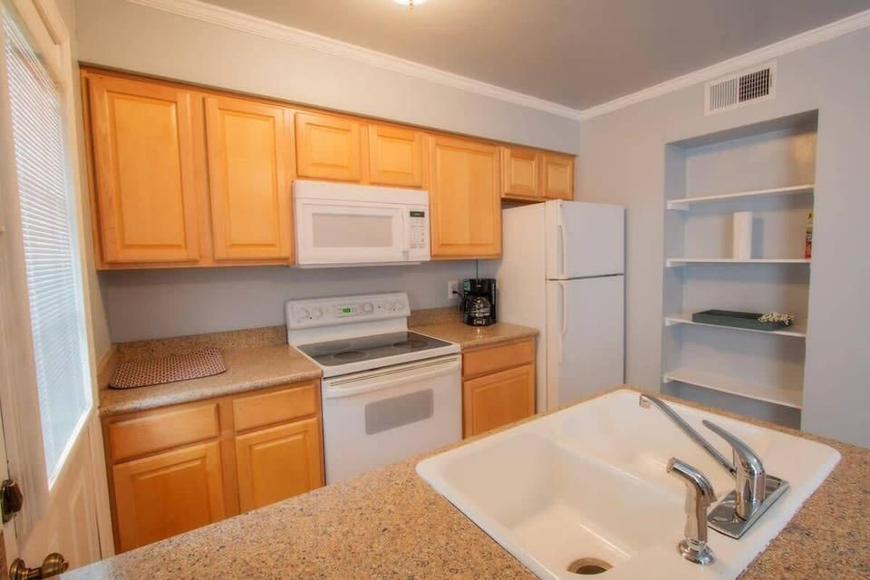 Fully equipped kitchen with pots, pans, plates, bowls, utensils, fire extinguisher and everything you need for meals