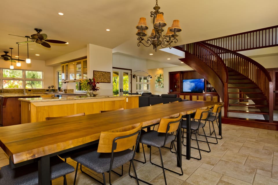 Dinning area with mahogany floating stair in the back