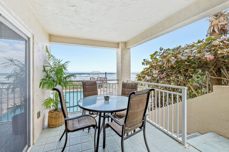 Private balcony space overlooking the ocean and pool.