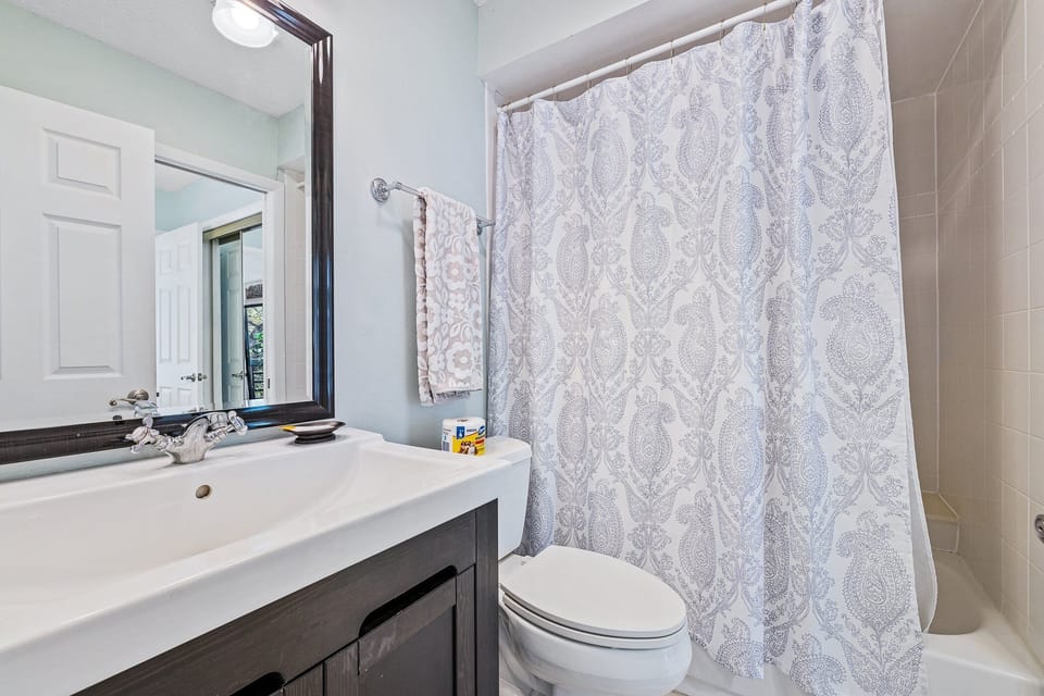 The bathroom has a tub/shower combo.