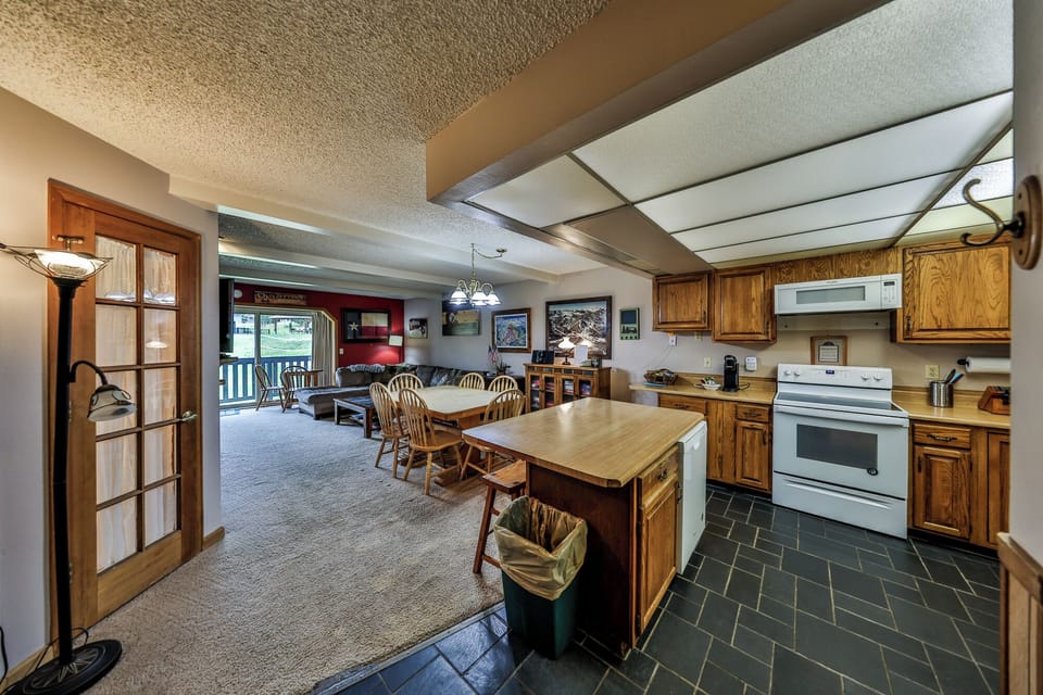 Your spacious kitchen features warm wood cabinets and flows seamlessly into the dining area, perfect for family meals and gathering together.