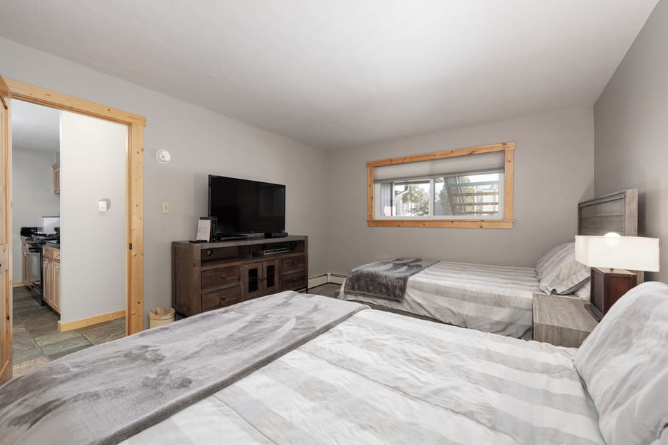 Rest comfortably in your spacious twin bedroom with modern amenities and peaceful mountain views through your private window.