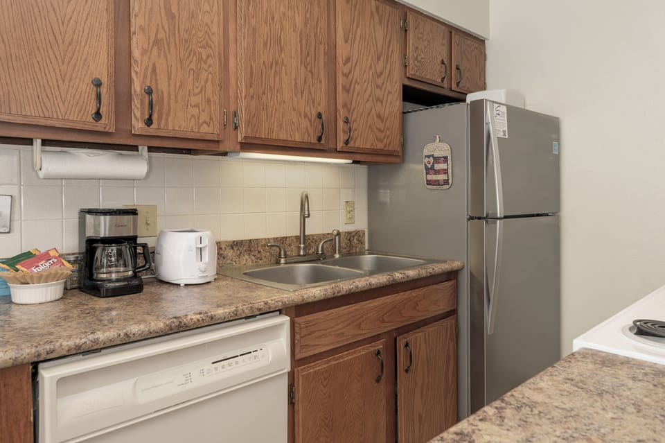 Your fully-equipped kitchen features granite counters, stainless appliances, and rich oak cabinets—perfect for preparing meals during your stay.