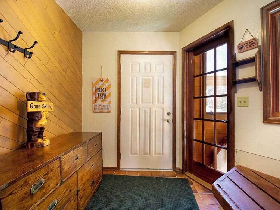 Step into your cozy mountain retreat where rustic charm meets comfort. Warm wood accents and skiing memorabilia welcome you home.