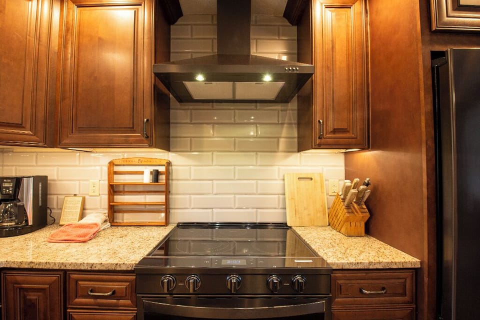Your gourmet kitchen features granite counters, rich cabinetry, and premium appliances ready for your culinary adventures.