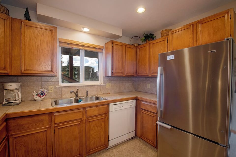 Your fully equipped kitchen features stainless appliances and warm wood cabinets, perfect for preparing meals during your stay.