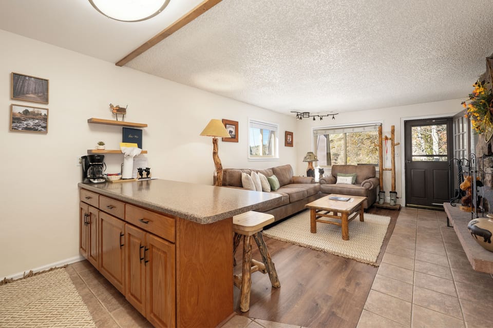 Unwind in your cozy living space where rustic charm meets modern comfort. The open layout flows seamlessly from kitchen to lounge, perfect for relaxing after mountain adventures.