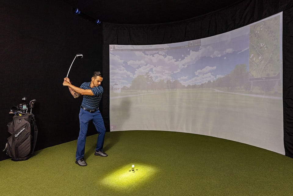 This High-Tech Sports Simulator Room features a SwingTrack Elite simulator with 87 PGA Golf Courses and 13 Sports Games