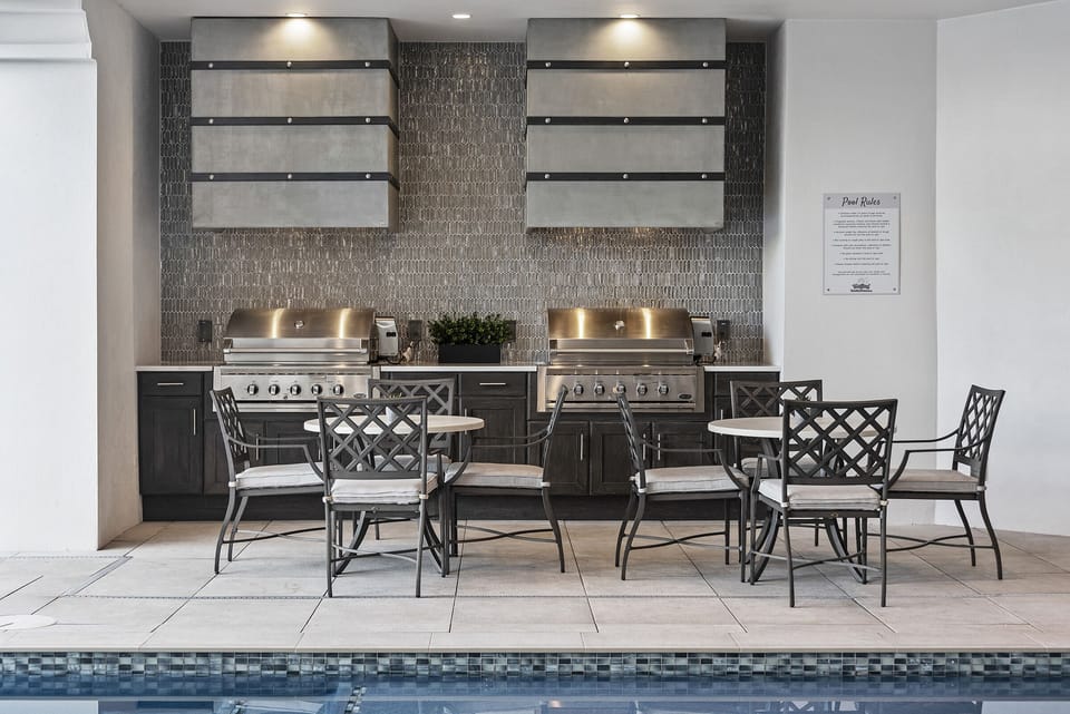 Enjoy the gorgeous outdoor living space, complete with a summer kitchen, wet bar and plenty of comfortable outdoor seating