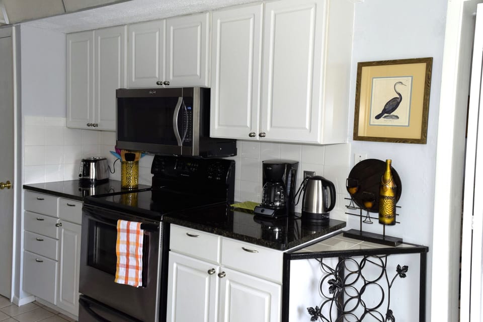 Kitchen with granite countertops and microwave exhaust combo