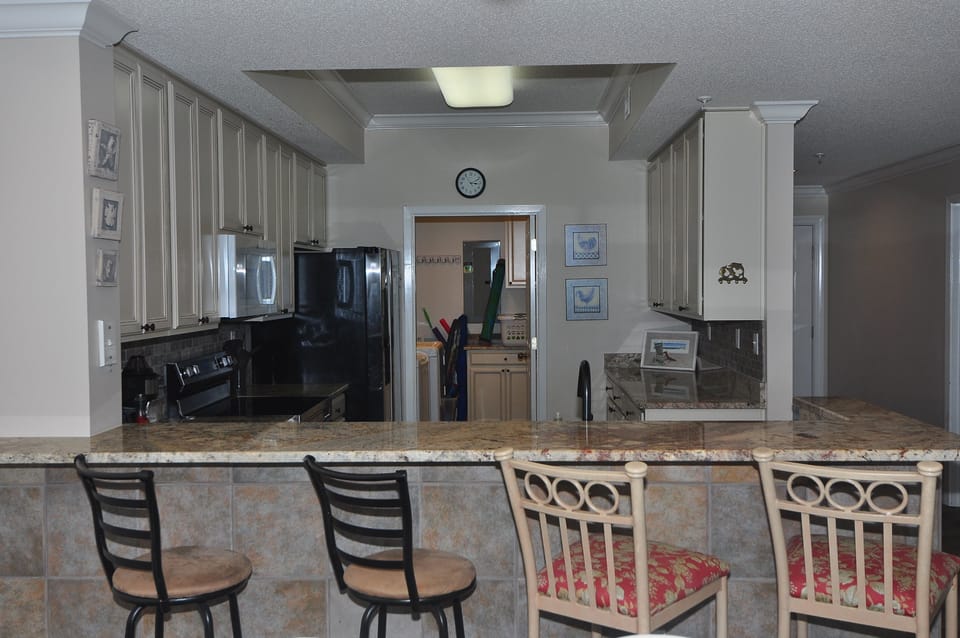 Spacious kitchen and breakfast bar with seating for four.