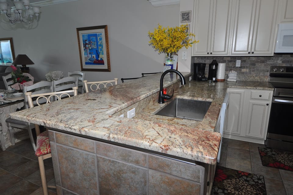 Updated kitchen with new granite countertops and wood cabinets.