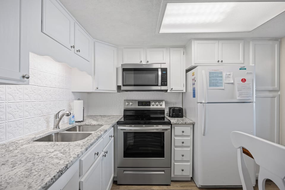 Full-size kitchen with new granite countertop and backsplash