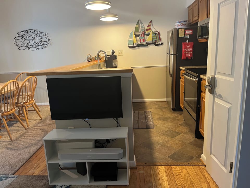 Kitchen area with fridge/freezer, oven, range, microwave.