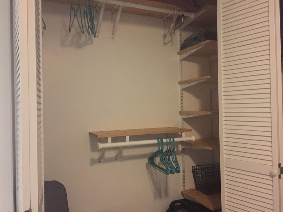 Large closet in master bedroom with plenty of storage and iron/ironing board too