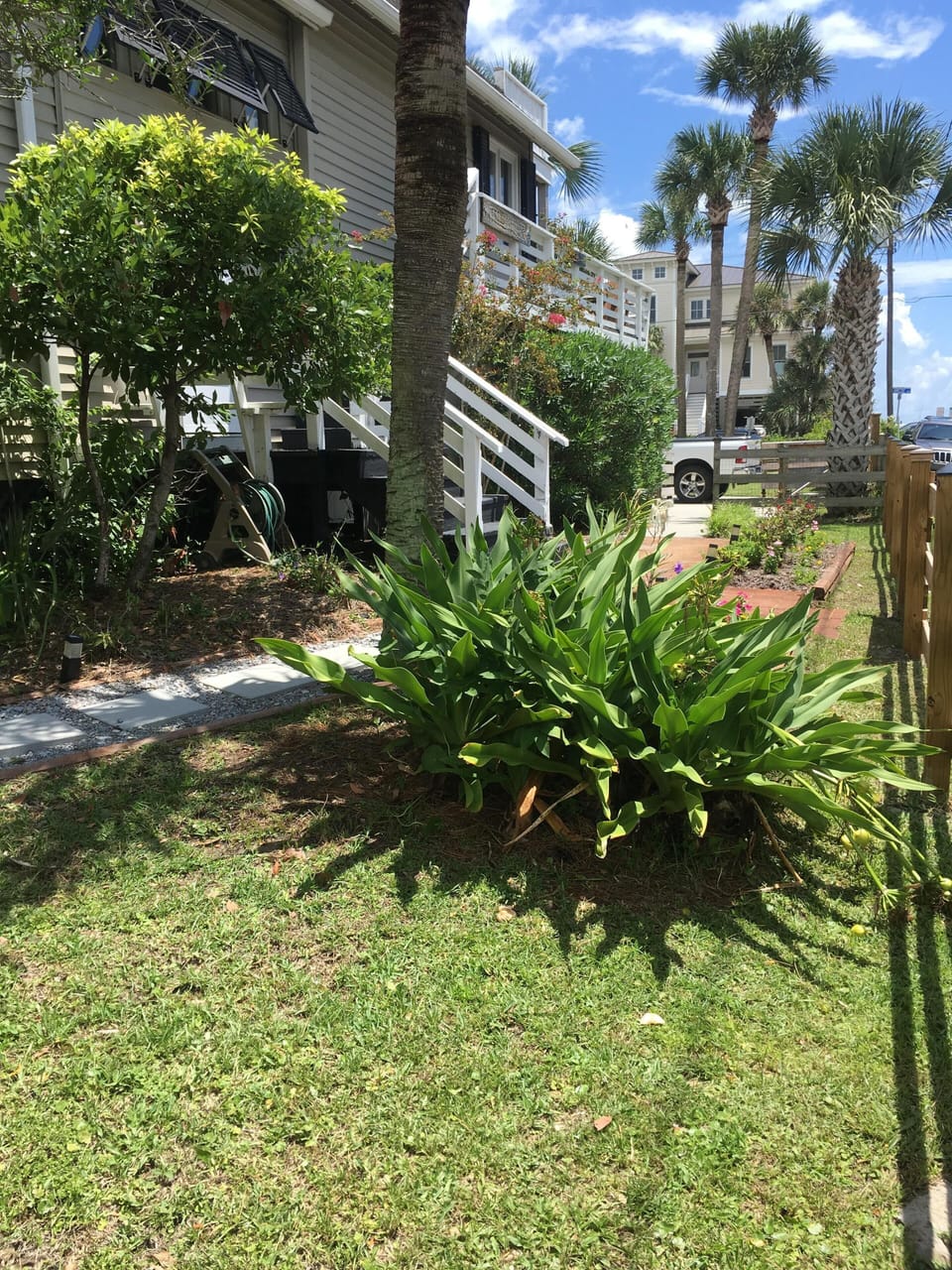 Side yard, front door entrance. Road leads to the beach access.