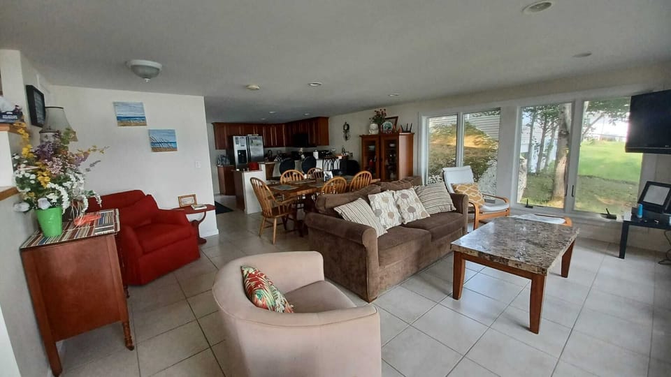 Perfect Lakefront Getaway, Maine - Living room with large panoramic windows.
