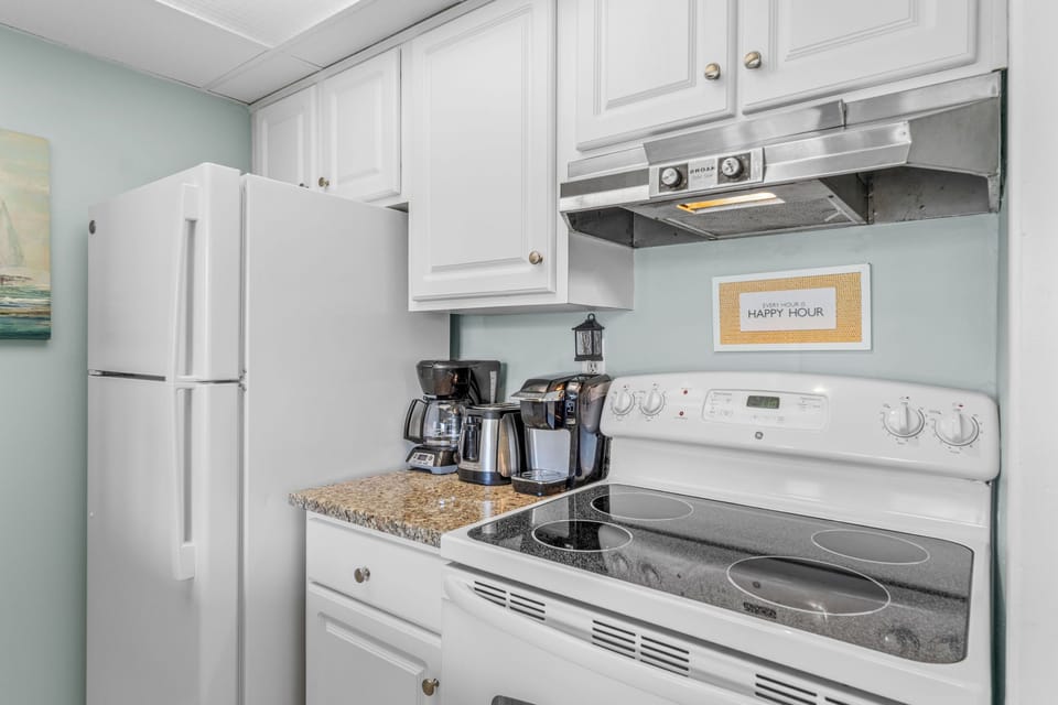 Your fully equipped kitchen awaits with granite counters, stainless appliances, and coffee maker ready for your morning brew.