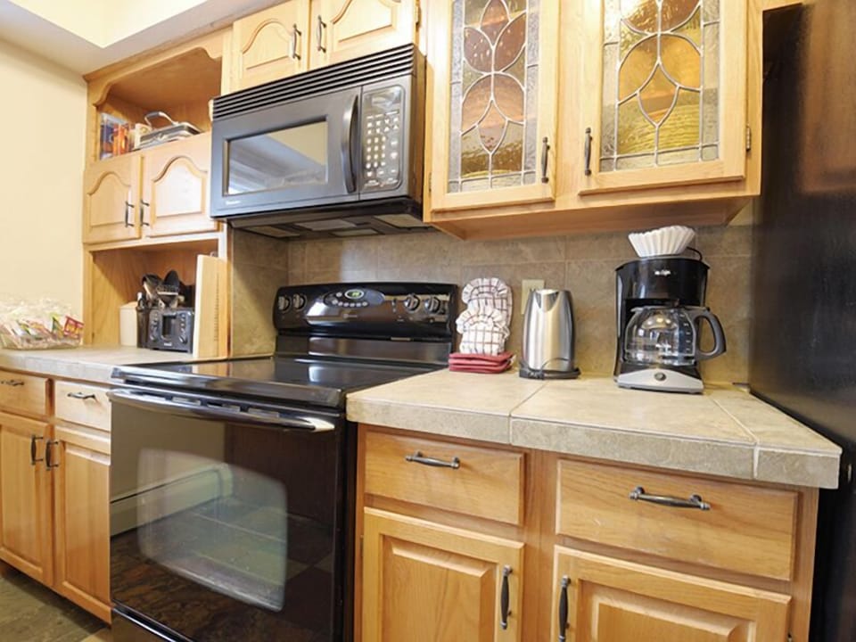 Your fully equipped kitchen features warm wood cabinets, modern appliances, and everything you need to prepare meals during your stay.