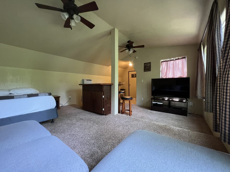 Bunkhouse - 55” Roku smart tv, full size bed, and bar w/ stools.  