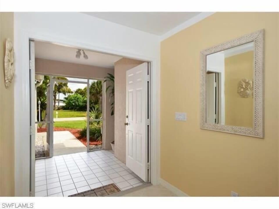 Front entrance with views across street to pond