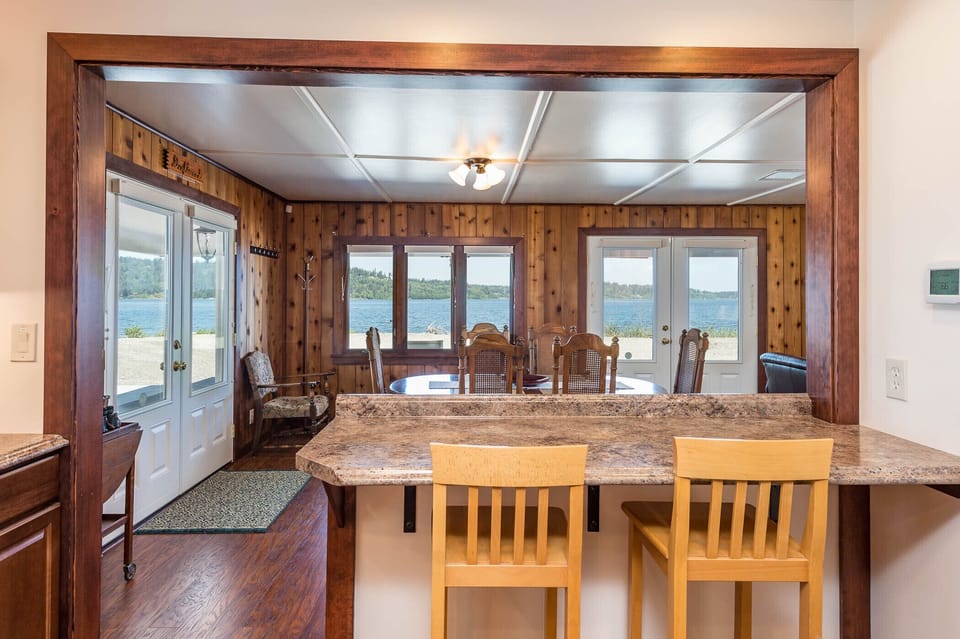 Kitchen counter seating open to dining area. 