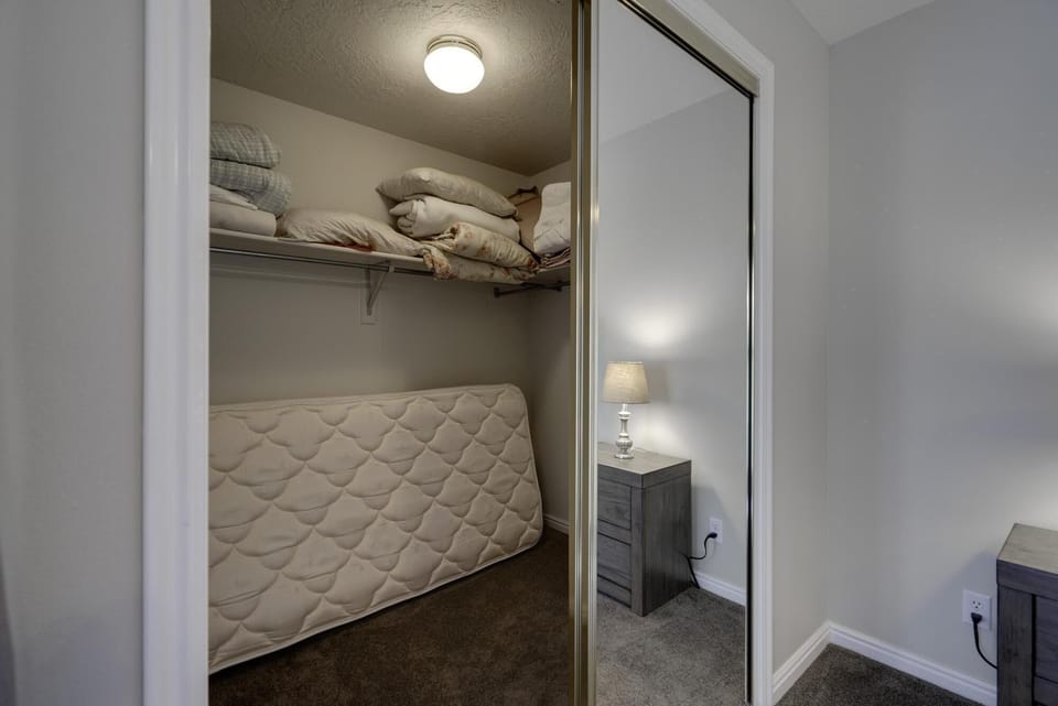 Master bedroom walk-in closet.  Twin mattress for extra sleeping.