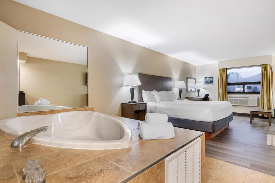 Suite, 1 King Bed, Non Smoking, Jetted Tub | Pillowtop beds, desk, laptop workspace, iron/ironing board