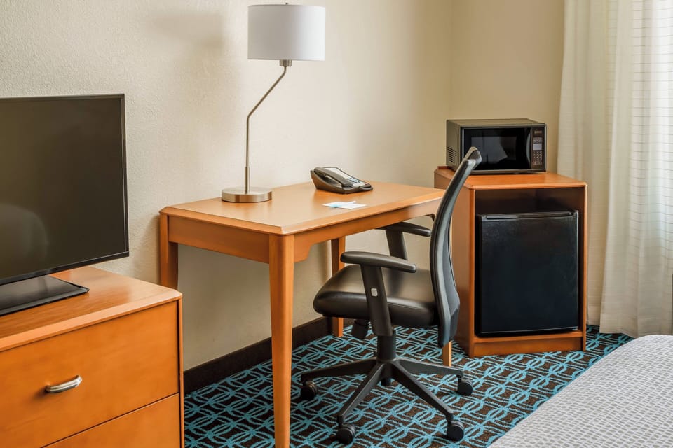 Desk, laptop workspace, blackout drapes, iron/ironing board