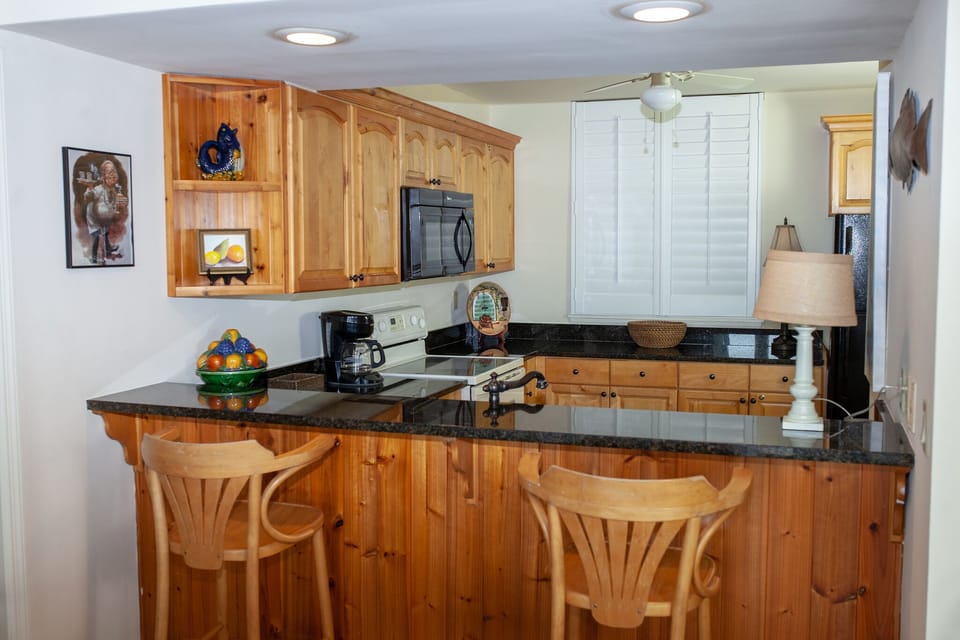 Kitchen , custom cabinetry, granite surfaces 