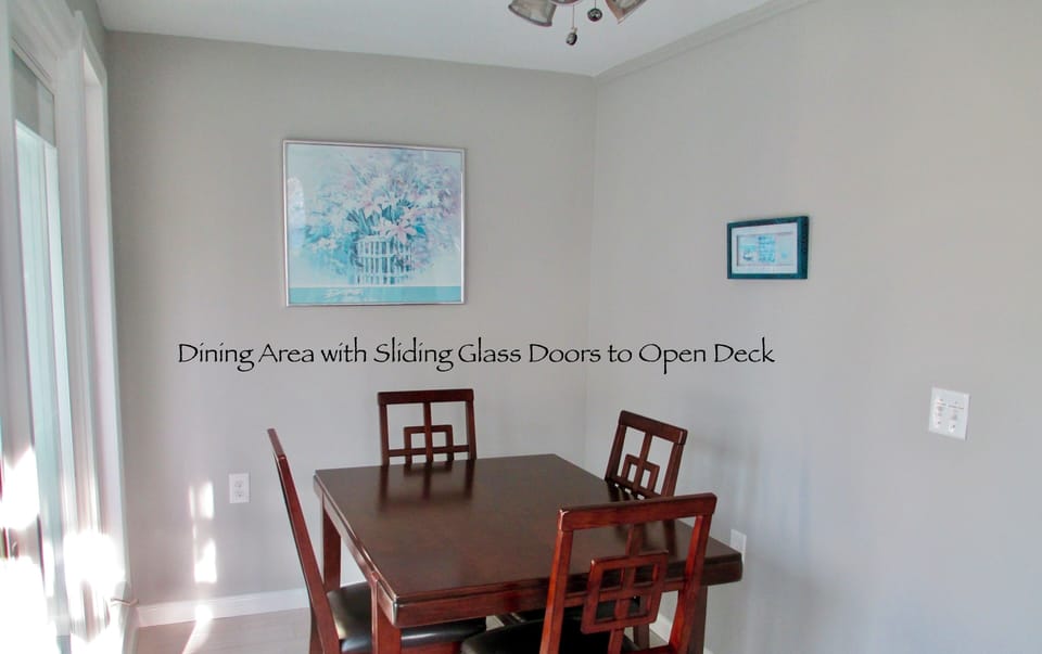 Dinning Room with Sliders to open deck and patio furniture.