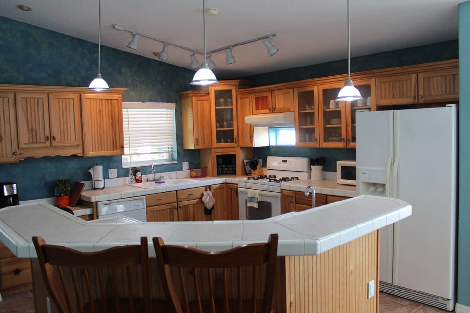 Kitchen with Island and Bar Stools. Plenty of Cabinet Space. 
