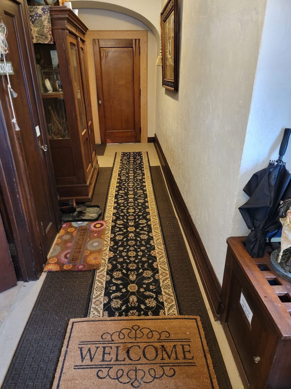 Side door hallway to the upstairs apartments w/ historical photos 