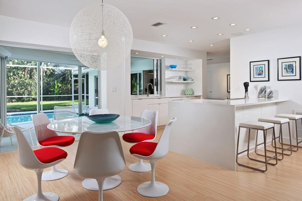 Dining area comfortably seats 6 with 3 more at adjacent bar.  Opens to pool.