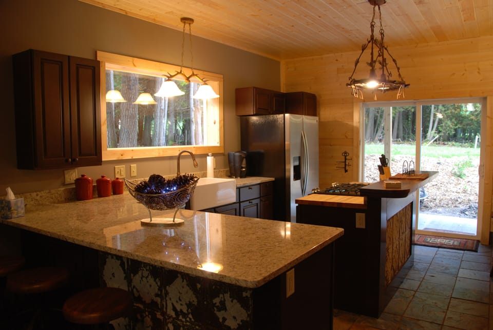 The kitchen features granite countertops and stainless steel appliances.