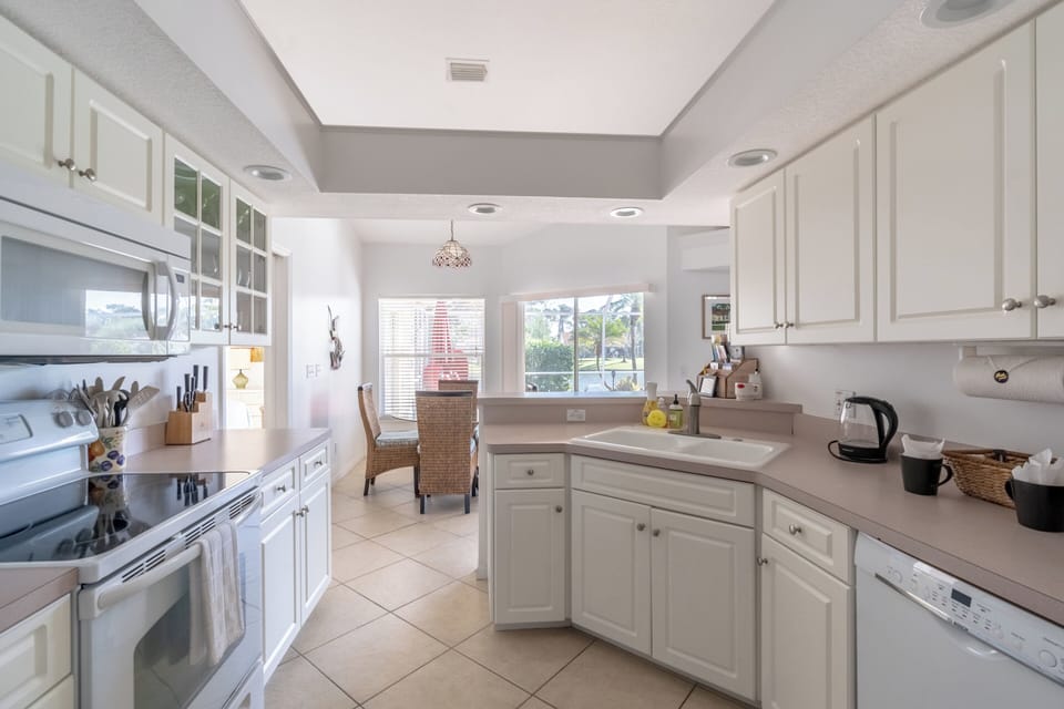 Fully stocked kitchen with oven, microwave, utensils, coffee machine and kettle