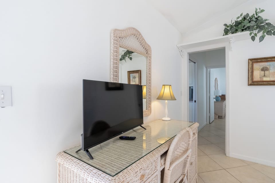 Queen bedroom looking onto lanai, HD TV and direct access to half bathroom